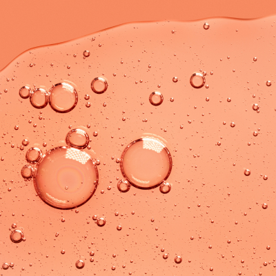 Flüssiges Gel auf orangem Hintergrund
