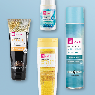 BI CARE Haarpflege: Shampoo, Spülung, Repair-Creme, Volumen-Spray & Anti-Schuppen-Kur auf blauem Hintergrund.