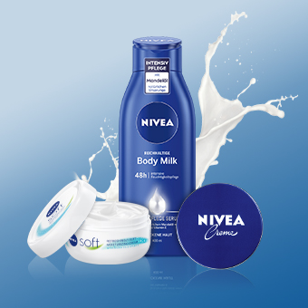 NIVEA Body Milk, Creme & Soft Creme vor blauem Hintergrund mit spritzender Milch – intensive Körperpflege. - Link zur Markenseite/Körperpflege