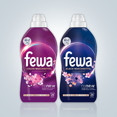 Zwei Fewa Blüten Waschmittel für bunte & schwarze Wäsche vor grauem Hintergrund – Farbschutz & Pflege. - Link zur Markenseite/Blüten Waschmittel