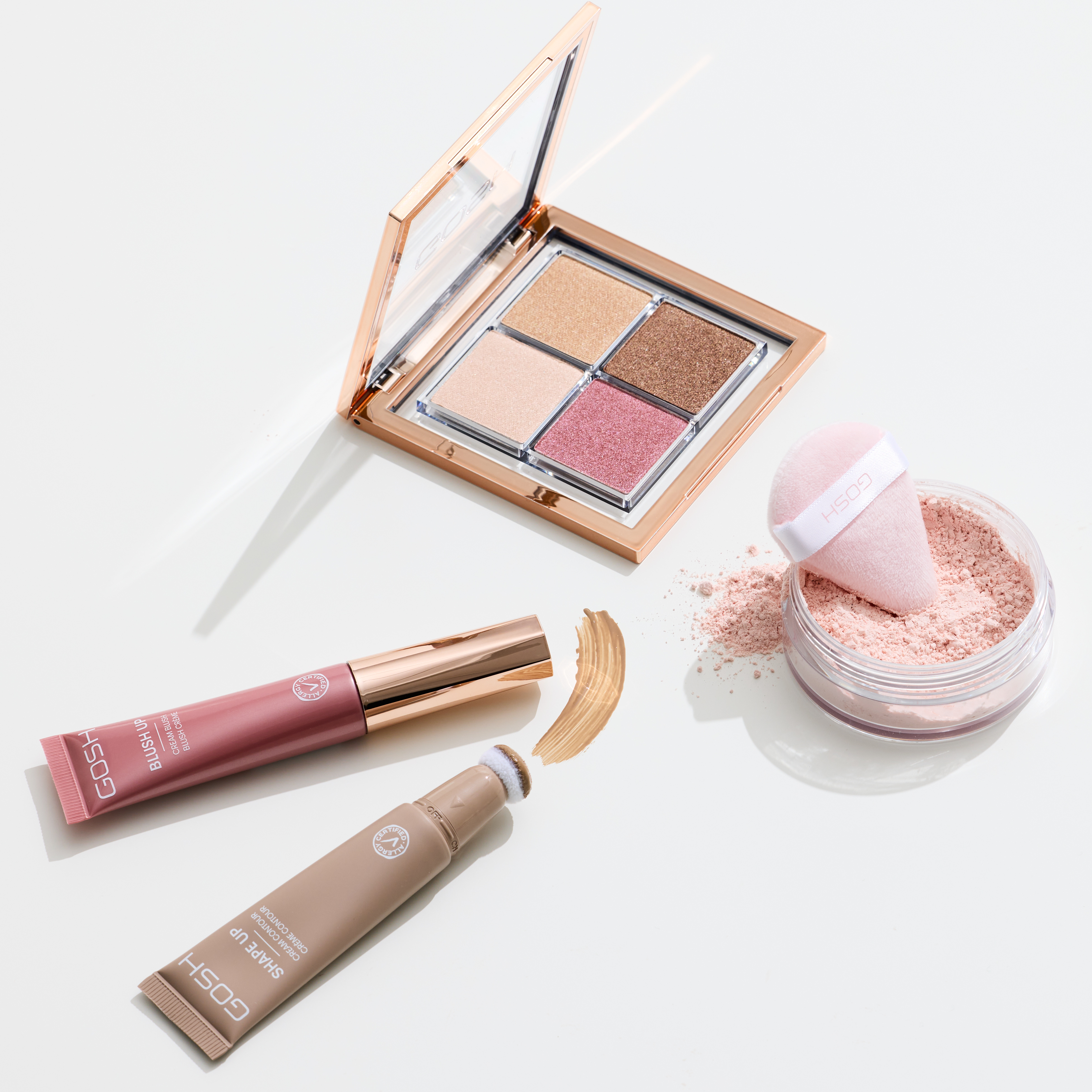 GOSH Make-up-Set mit Lidschatten, Rouge, Foundation & Puderquaste – Kosmetikprodukte auf weißem Hintergrund.