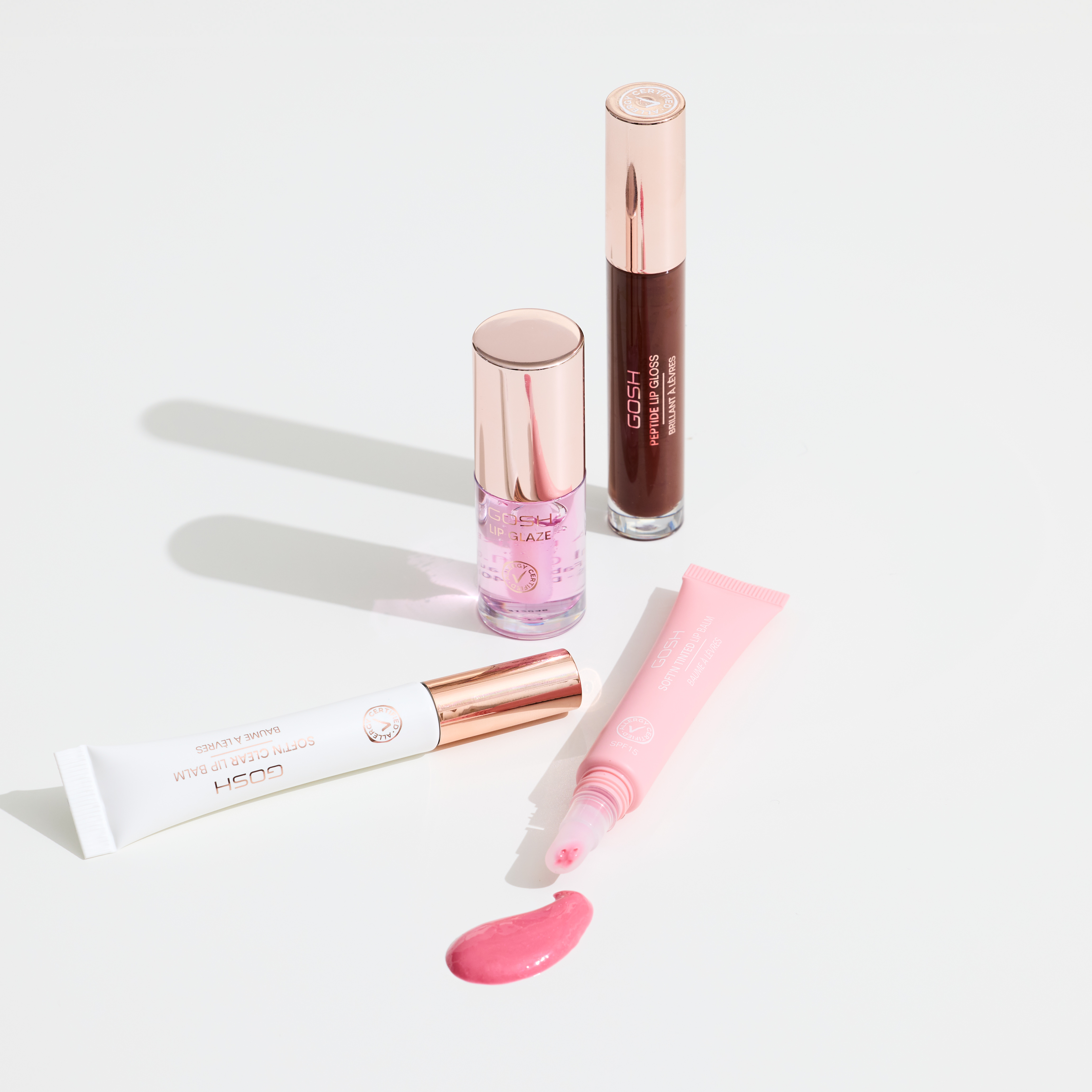GOSH Make-up: Nagellack, Lipgloss, Handcreme & Lipbalm auf weißem Hintergrund – Beauty-Essentials für gepflegten Sommerlook.