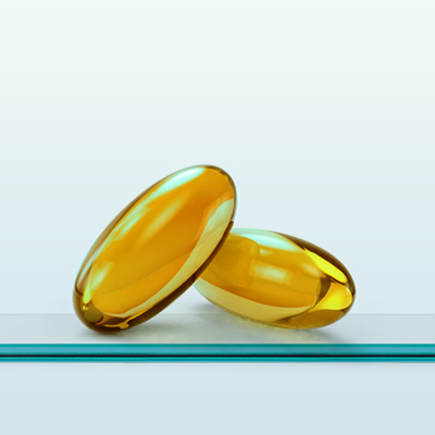 Zwei gelbe Kapseln vor hellem Hintergrund.