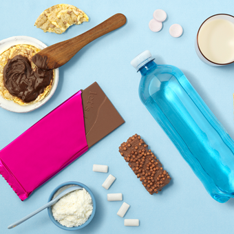 Icon für Ernährung- Wasserflasche, Schokolade, Aufstrich und Kaugummi auf blauem Hintergrund.