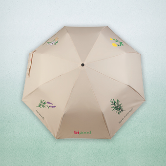 Beiger Regenschirm mit floralen Illustrationen und bi good Logo, dekorativer Sonnenschutz für Outdoor und Alltag.