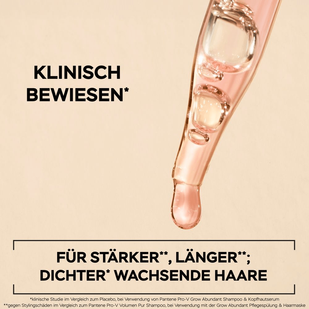 Eine transparente Pipette, gefüllt mit einem rosafarbenen, öligen Serum, hält einen großen Tropfen an ihrer Spitze. Der Hintergrund ist beige. Darüber steht in schwarzer Schrift: KLINISCH BEWIESEN. Darunter steht: FÜR STÄRKERES, LÄNGERES & DICHTERES HAAR*